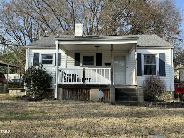 view of front of property with a porch and a front yard