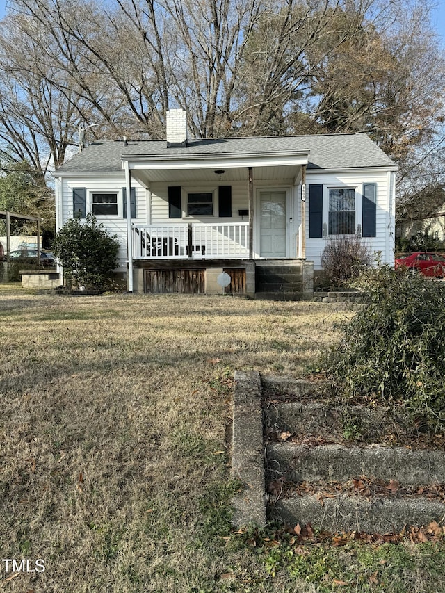 view of front of house featuring a front yard and a porch