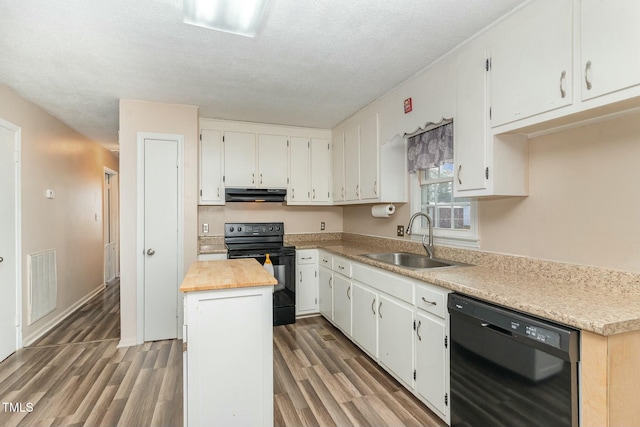 kitchen featuring white cabinets, sink, a kitchen island, and black appliances