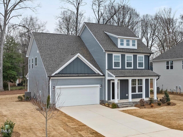 view of front of house featuring a garage, a porch, and cooling unit