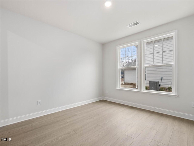 spare room featuring light hardwood / wood-style flooring