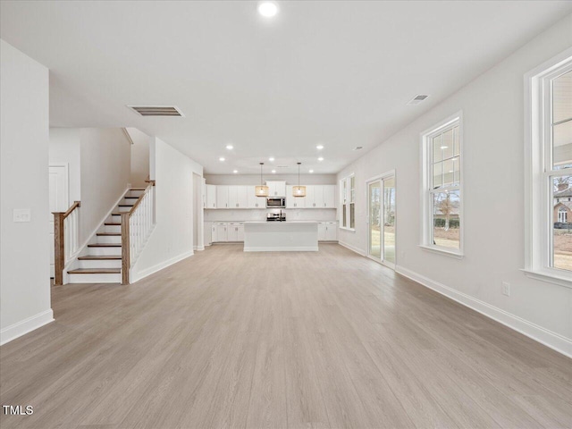 unfurnished living room featuring light wood-type flooring