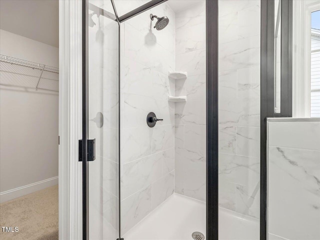 bathroom featuring a shower with shower door