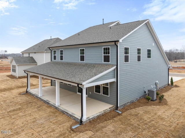 rear view of property with a patio and central air condition unit