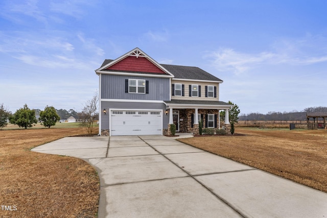 view of front of property with a front lawn, covered porch, and a garage