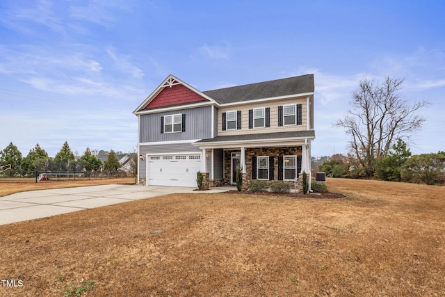 craftsman-style house featuring a garage, central air condition unit, a front lawn, and a trampoline