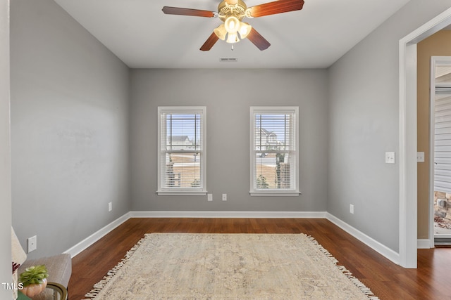 unfurnished room featuring ceiling fan and dark hardwood / wood-style flooring