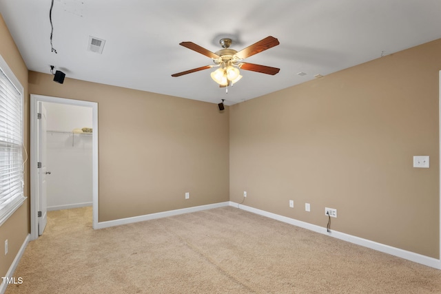 unfurnished room with ceiling fan and light carpet