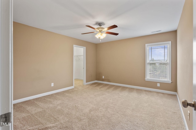 carpeted empty room featuring ceiling fan