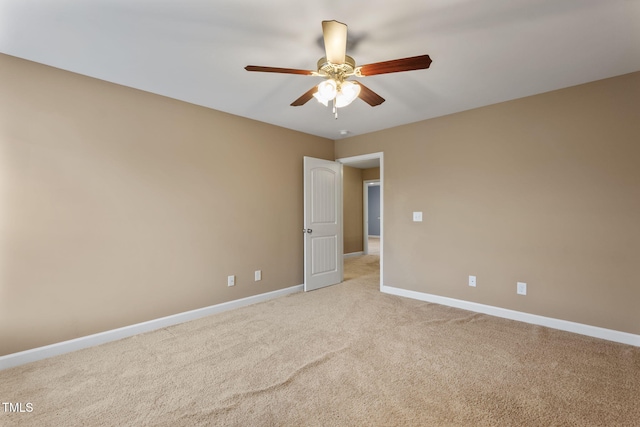 spare room featuring ceiling fan and light colored carpet