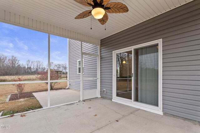 unfurnished sunroom featuring ceiling fan