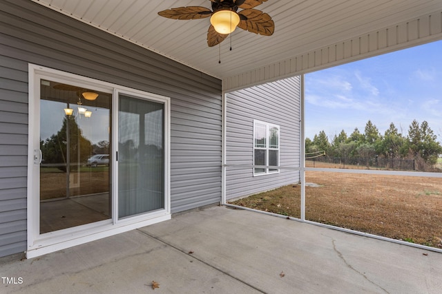 unfurnished sunroom featuring ceiling fan