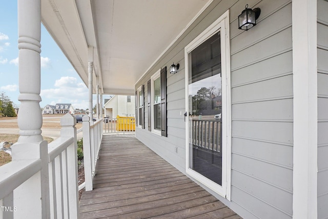 wooden terrace featuring covered porch