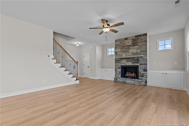 unfurnished living room featuring light hardwood / wood-style flooring, ceiling fan, and a healthy amount of sunlight