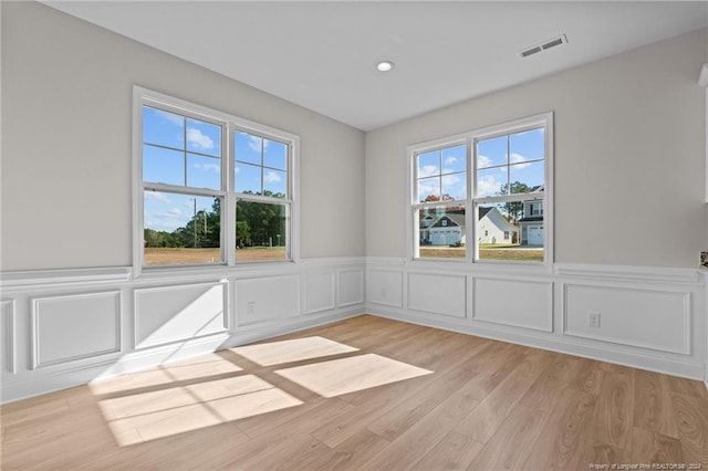 spare room featuring light hardwood / wood-style floors