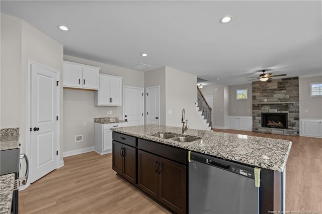 kitchen with ceiling fan, sink, white cabinets, and stainless steel dishwasher