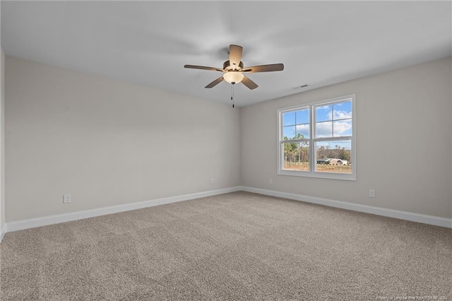 carpeted spare room with ceiling fan