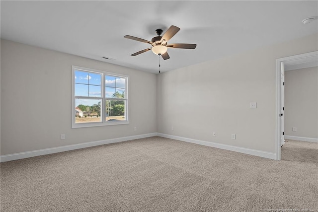 carpeted spare room featuring ceiling fan