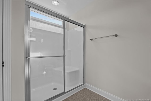 bathroom featuring a shower with door and tile patterned flooring