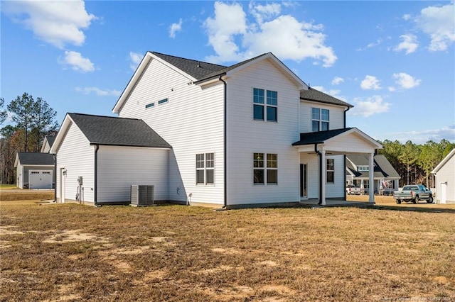 rear view of property featuring a lawn, a porch, and central air condition unit