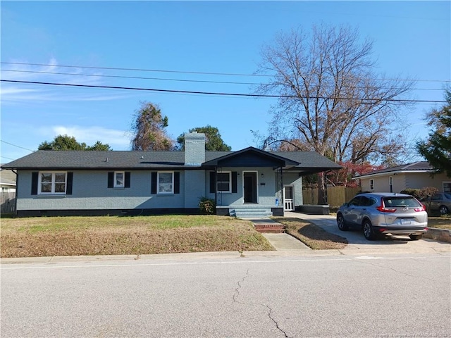 single story home featuring a porch and a front lawn