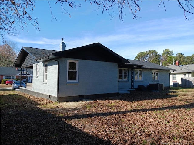 view of side of home featuring central AC unit