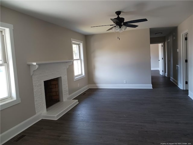 unfurnished living room featuring dark hardwood / wood-style floors and ceiling fan