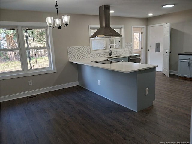 kitchen featuring stainless steel dishwasher, decorative backsplash, dark hardwood / wood-style floors, decorative light fixtures, and island range hood