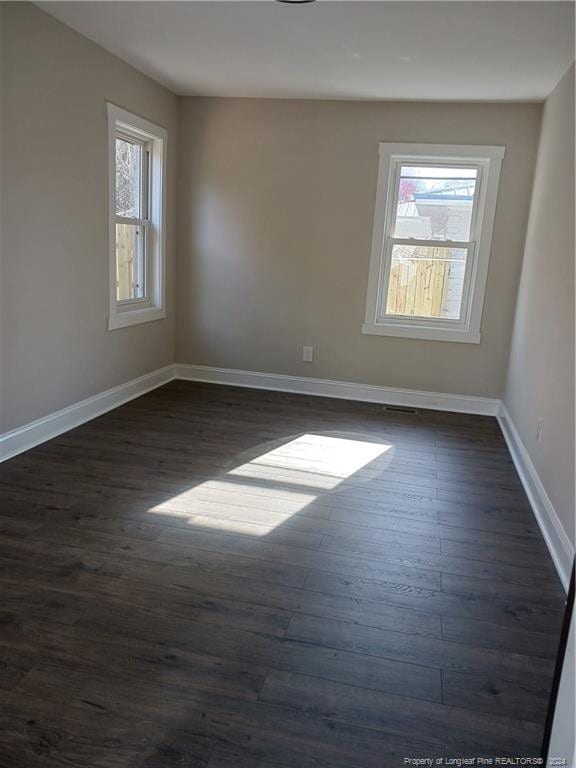 empty room featuring dark hardwood / wood-style flooring