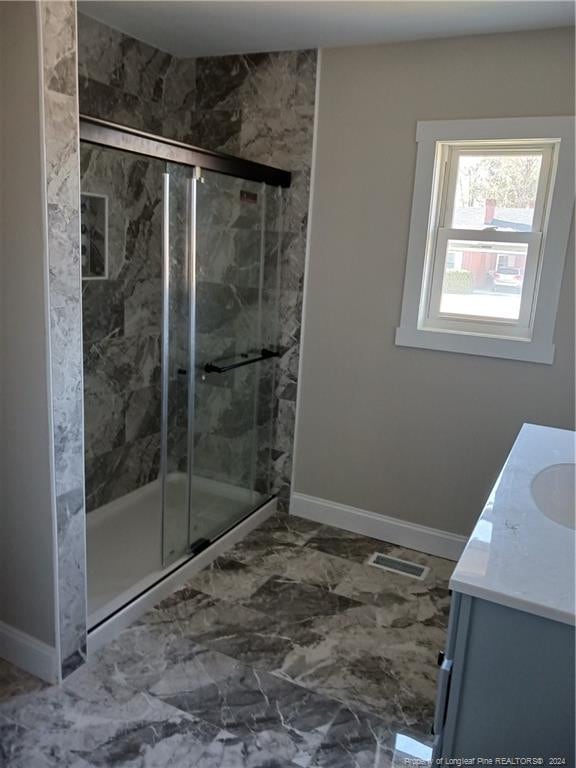 bathroom featuring vanity and a shower with shower door