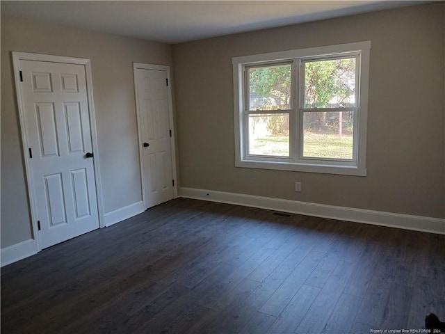 spare room featuring dark hardwood / wood-style flooring