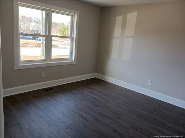 unfurnished room featuring dark wood-type flooring