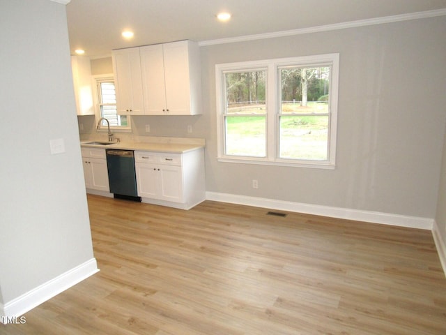 2253 NC Highway 96 S, Franklinton, NC 27525 - kitchen featuring dishwashing machine, crown molding, white cabinetry, light countertops, and light wood finished floors