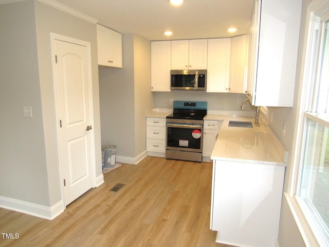 2253 NC Highway 96 S, Franklinton, NC 27525 - kitchen featuring appliances with stainless steel finishes, light wood finished floors, recessed lighting, light countertops, and white cabinetry