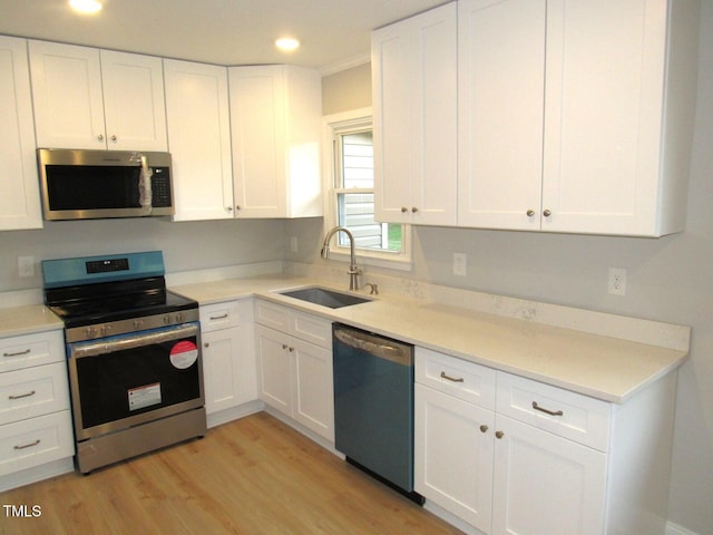 2253 NC Highway 96 S, Franklinton, NC 27525 - kitchen featuring stainless steel appliances, light wood-style floors, white cabinets, light countertops, and recessed lighting