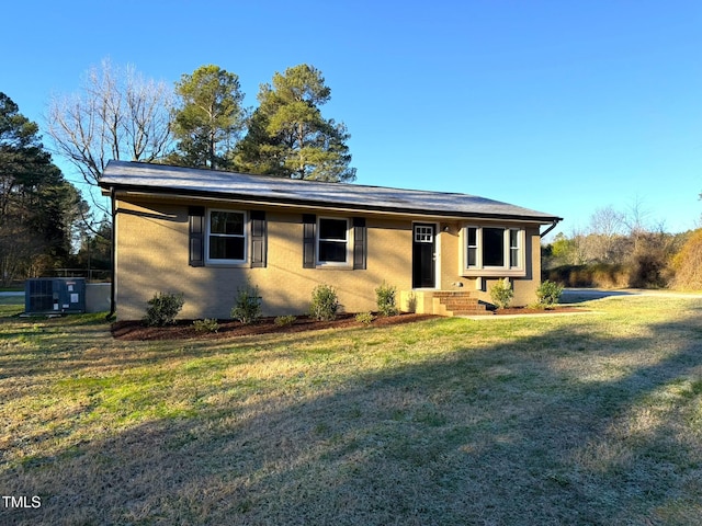 single story home featuring a front yard and central AC unit