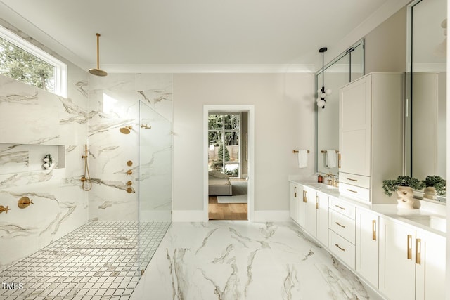 bathroom with crown molding, vanity, and tiled shower