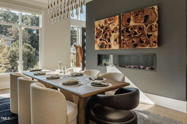 dining space featuring hardwood / wood-style flooring and an inviting chandelier