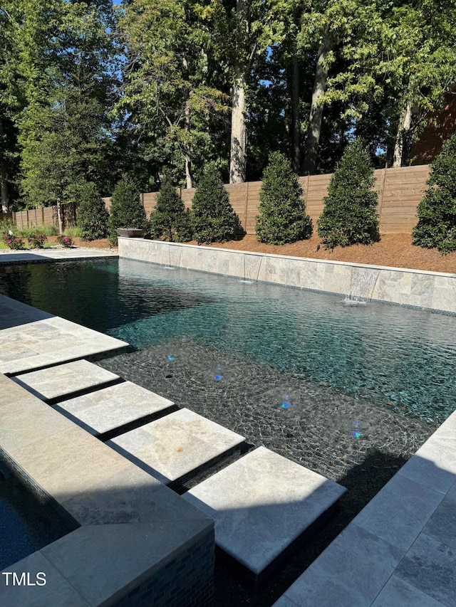 view of pool with pool water feature