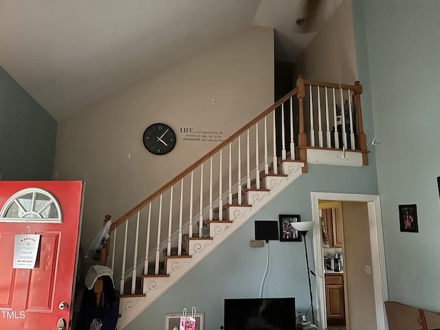 staircase featuring lofted ceiling