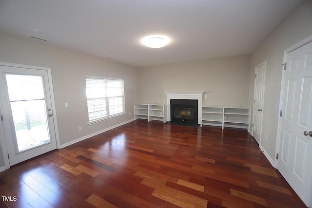 unfurnished living room with dark hardwood / wood-style floors