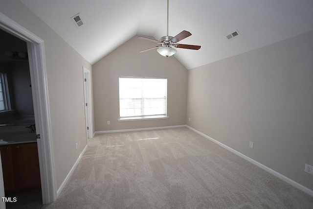 carpeted empty room featuring lofted ceiling and ceiling fan