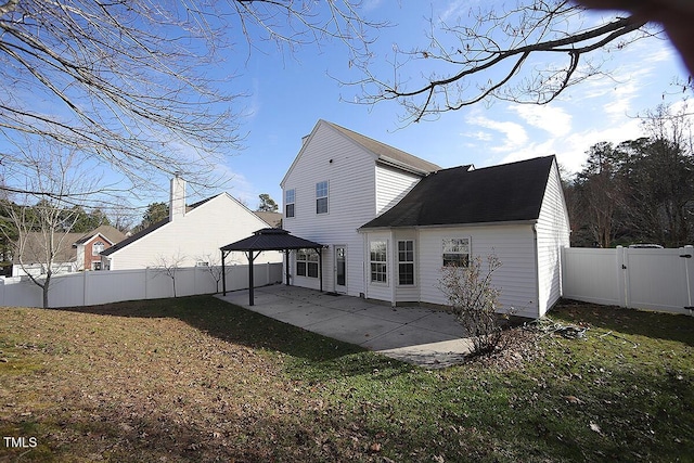 back of house with a gazebo, a yard, and a patio area