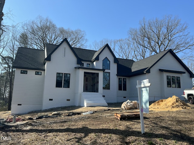 rear view of house featuring roof with shingles and crawl space