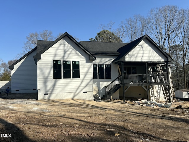 rear view of property featuring crawl space, dirt driveway, stairs, and a porch