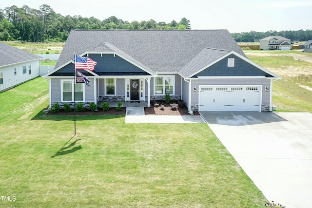 craftsman inspired home featuring an attached garage, covered porch, concrete driveway, and a front yard