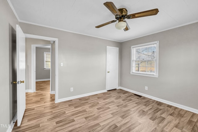 unfurnished bedroom with ceiling fan, light wood-type flooring, and ornamental molding