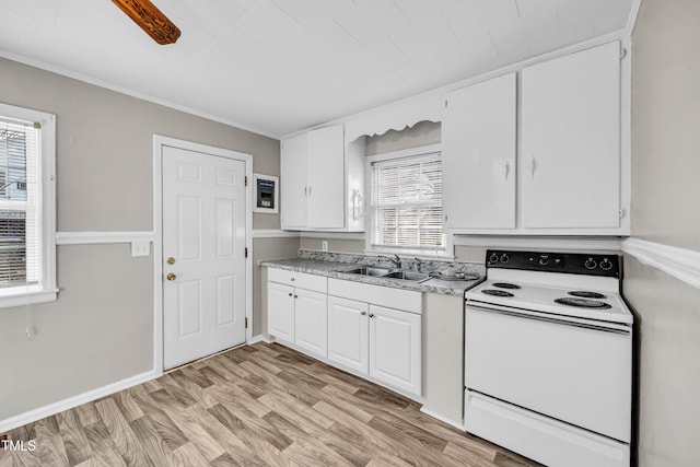 kitchen with white range with electric cooktop, sink, light wood-type flooring, a wealth of natural light, and white cabinetry