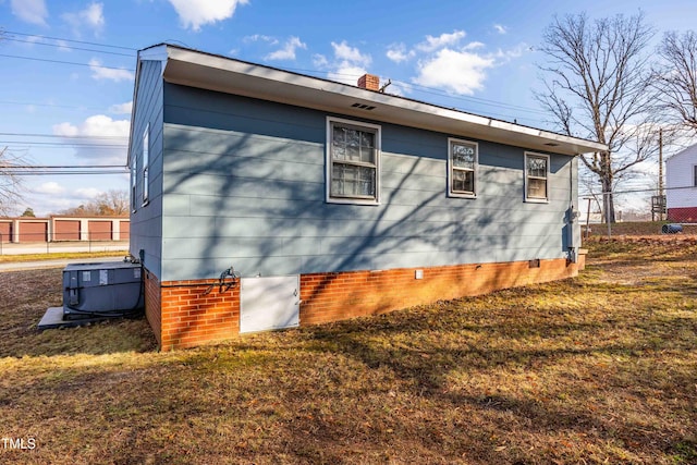 view of side of property featuring central AC