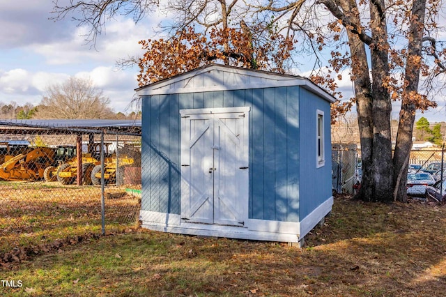 view of outbuilding featuring a lawn